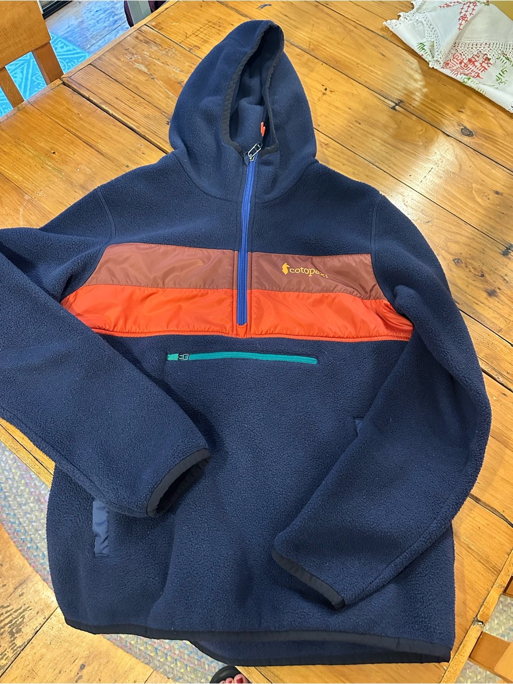 cotopaxi Navy Fleece Hoodie with Orange and Brown Chest Panels
